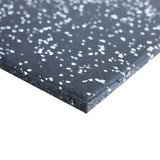 Close-up of a 15mm black rubber mat with white speckles on a white background