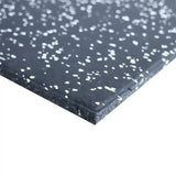 Close-up of a 15mm black rubber mat with white speckles on a white background