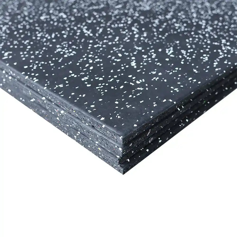 Close-up of a black rubber mat with white flecks on a white background
