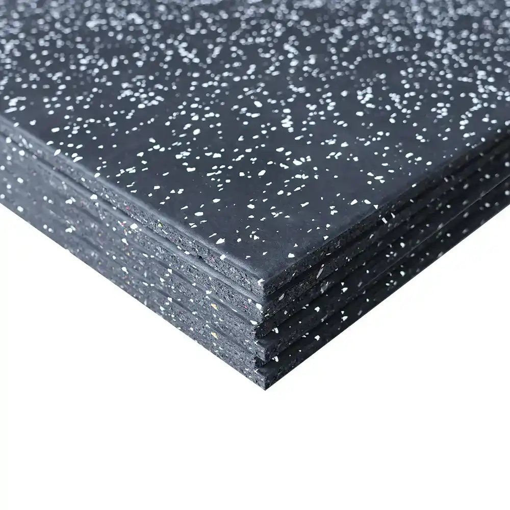 Stack of black rubber mats with white flecks on a white background