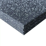 Stack of black rubber mats with white flecks on a white background