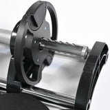 Close-up of a mechanical component with gears and metal shafts in a 32kg adjustable dumbbell