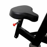 Black adjustable seat of bicep curl machine with a red adjustment knob