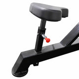Black adjustable seat of chest press machine on a white background