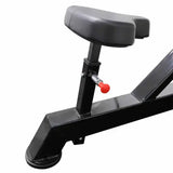Black adjustable seat of chest press machine on a white background