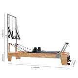 Wooden reformer Pilates machine with trapeze tower and black padded surface, dimensions shown