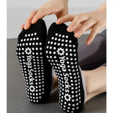 Black yoga socks with white non-slip dot and 'Yoga Socks' branding on a neutral background.