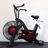 Black and red exercise bike with fan on a white background