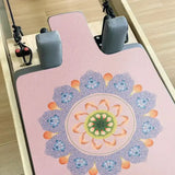pink lotus reformer mat on the reformer