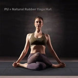 Woman sitting in a yoga pose on a dark yoga mat with text 'PU + Natural Rubber Yoga Mat'.