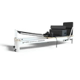 SuperAlphago Pilates reformer machine with black cushions and resistance bands on white background