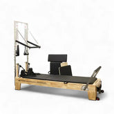 oak Pilates reformer with half trapeze tower