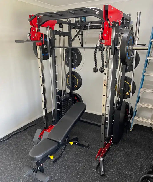 Smith machine and adjustable bench setup in a home gym.