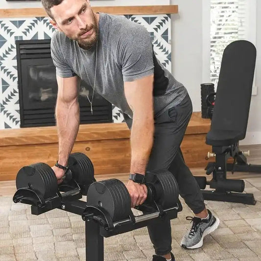 Man performing bent-over row using dumbbells in a home gym setting.