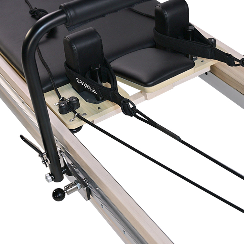 Close-up of the shoulder rest, headrest, and handlebar on a Pilates reformer