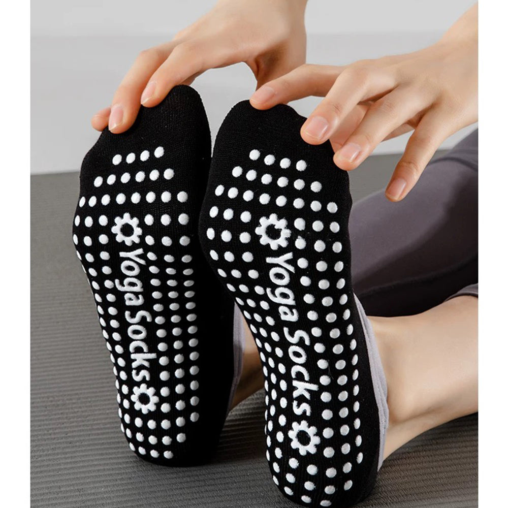 Black yoga socks with white non-slip dot and 'Yoga Socks' branding on a neutral background.
