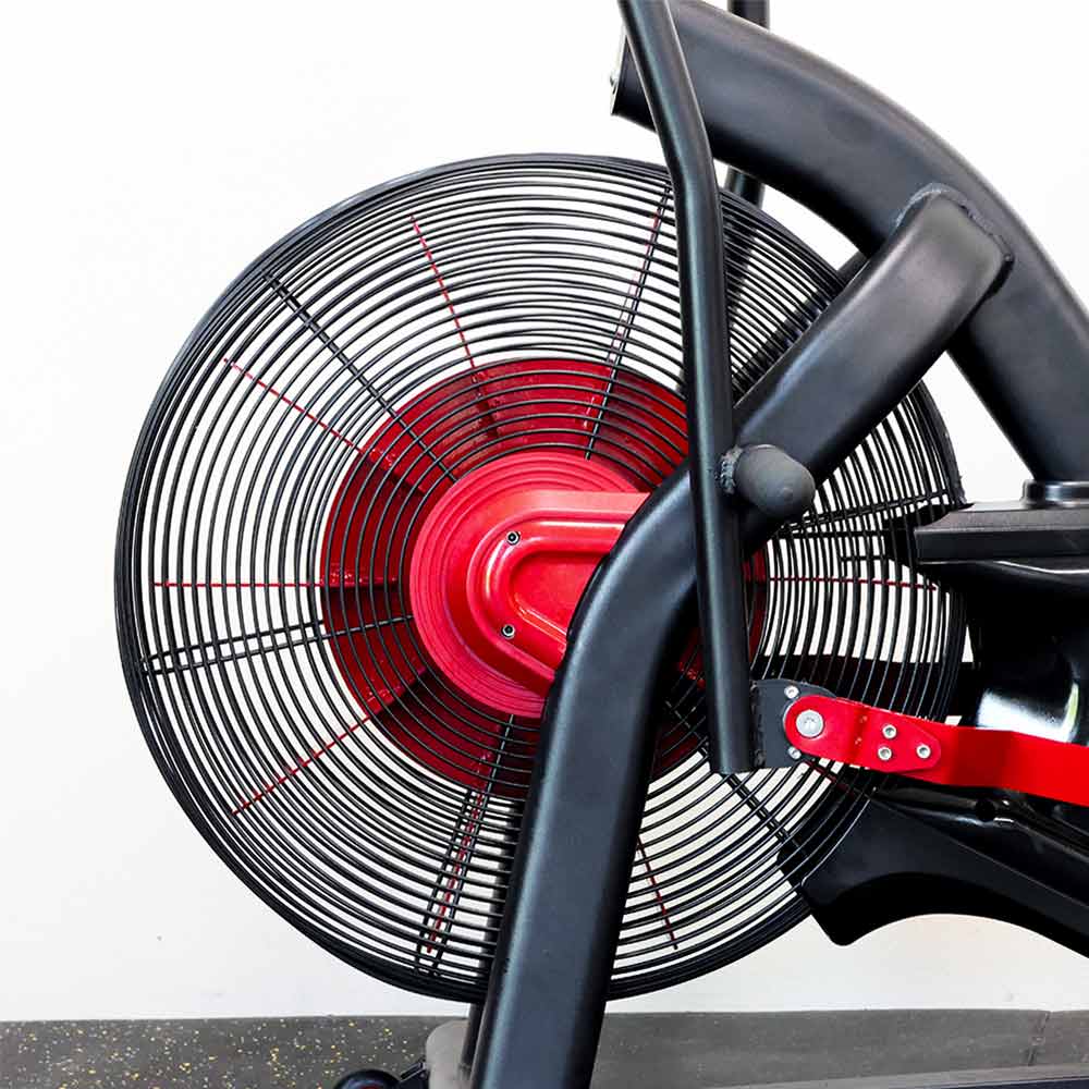 Close-up of a red and black exercise bike fan on a white background